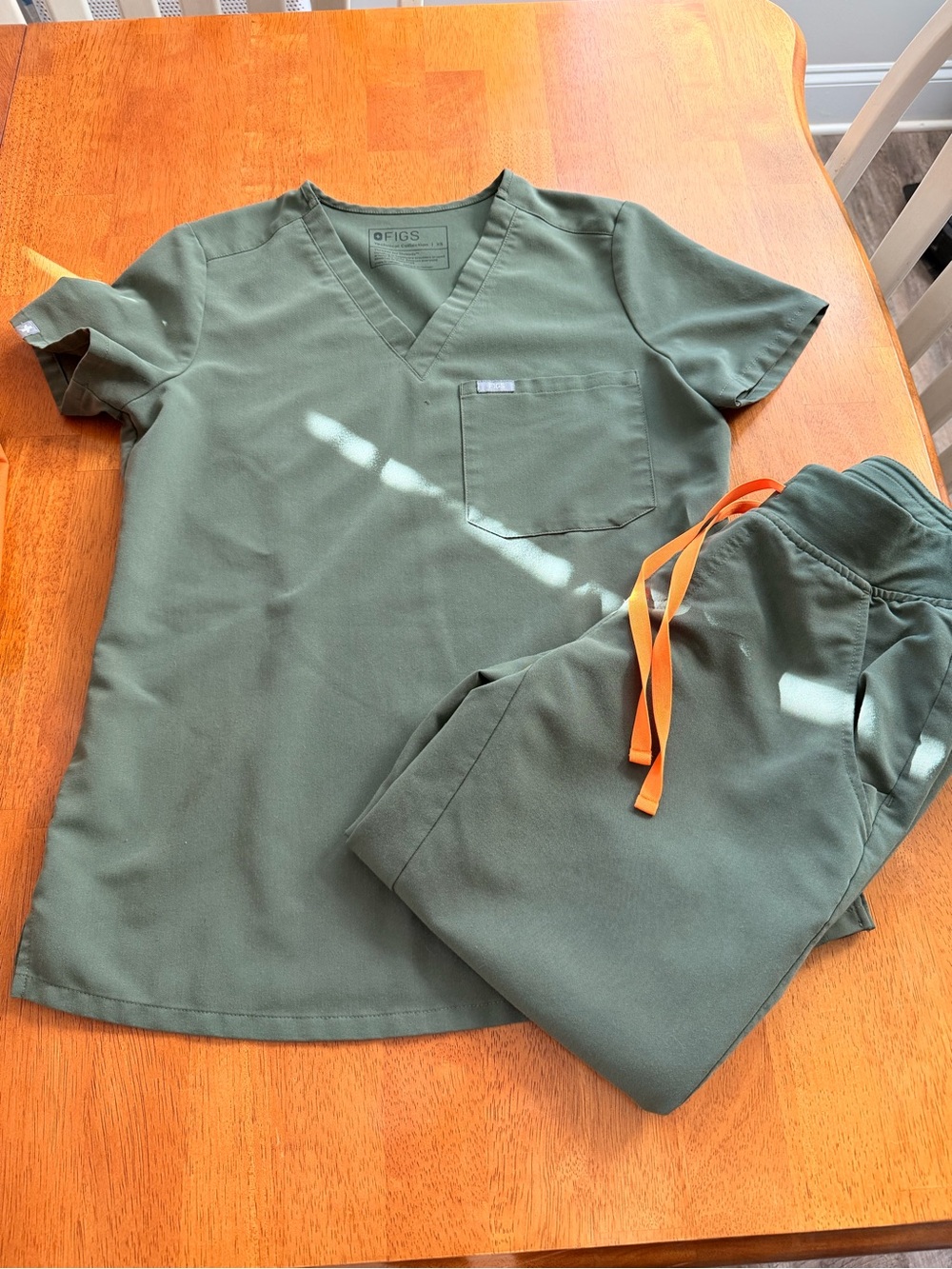 FIGS Women’s Olive Green Scrub Top and Jogger Set with Orange Drawstring